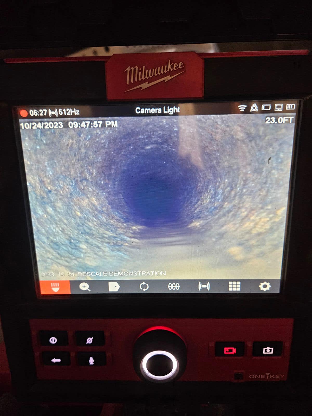 A digital display shows a live camera feed of the inside of a pipe or tunnel, with various controls and settings visible on the screen.